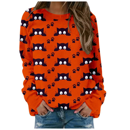 Orange sweatshirt with black cat pattern worn by a person on a white background