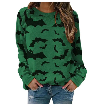 Green sweater with black bat patterns worn by a person on a white background