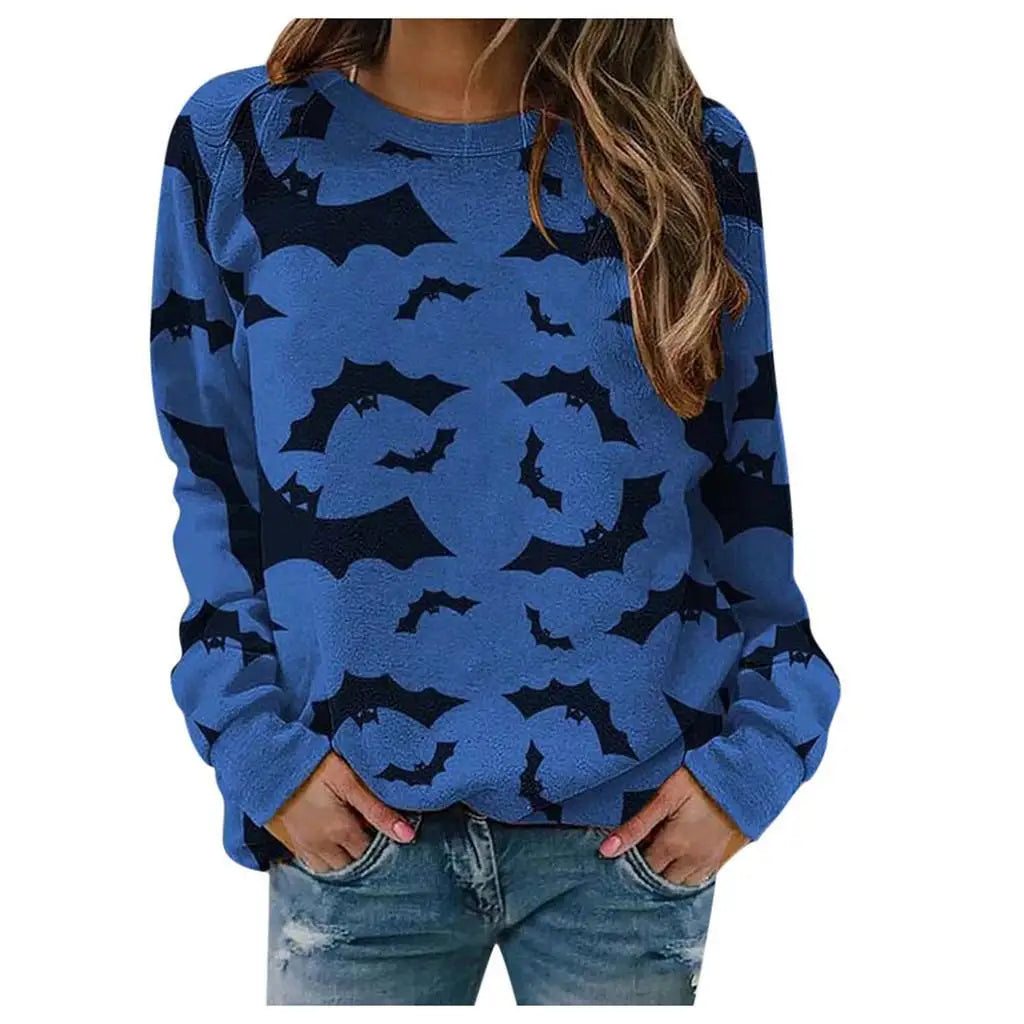 Blue sweater with black bat patterns worn by a person on a white background