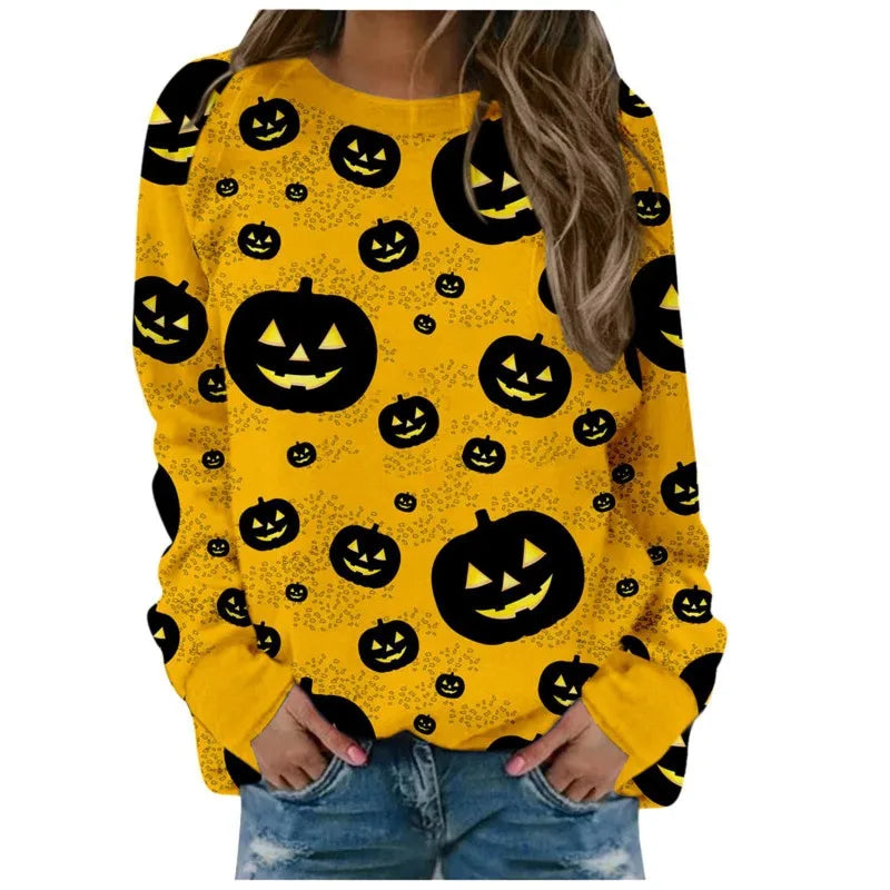 Yellow sweatshirt with black pumpkin patterns worn by a person on a white background