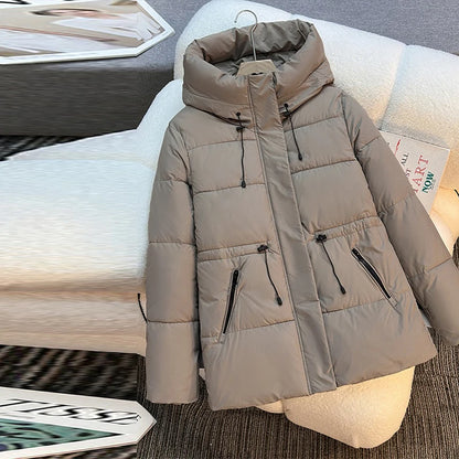 Beige puffer jacket on a mannequin with a blurred indoor background