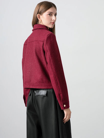 Woman wearing a red jacket on a plain background