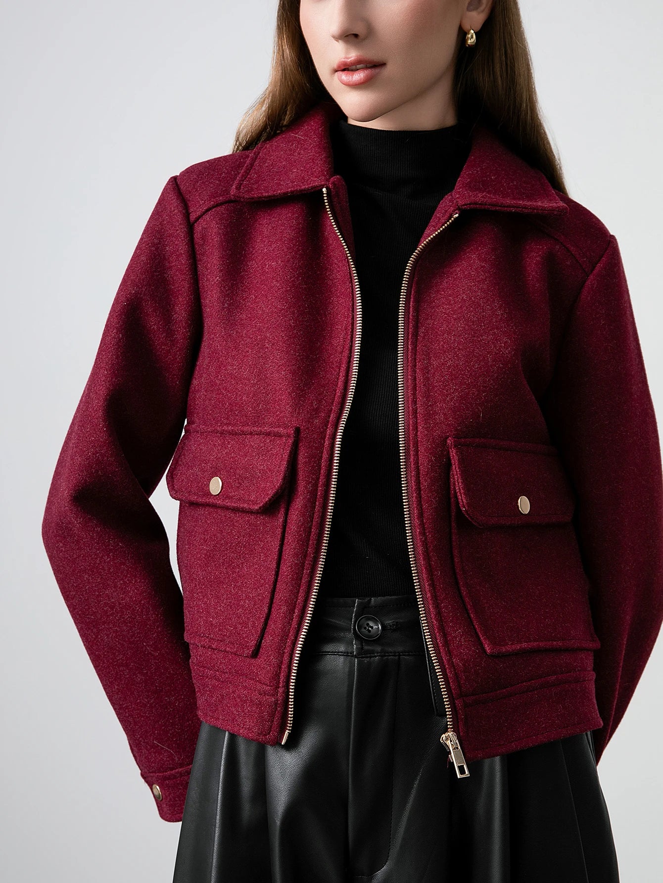 Maroon jacket worn by a person on a plain background