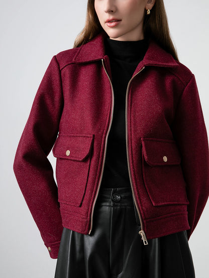 Maroon jacket worn by a person on a plain background