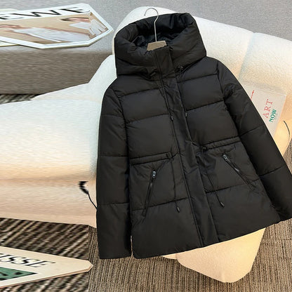 Black puffer jacket on a mannequin with a blurred indoor background