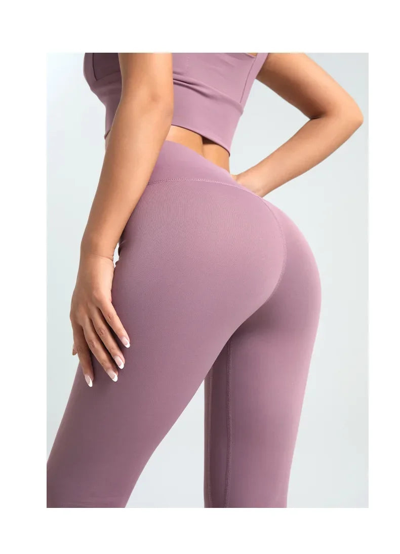 Mauve leggings worn by a person on a light gray background