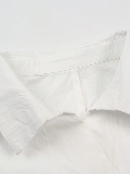 Close-up of a white pillow with visible stitching on a white background