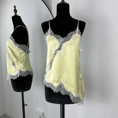 Light yellow lace-trimmed top on a mannequin against a plain background
