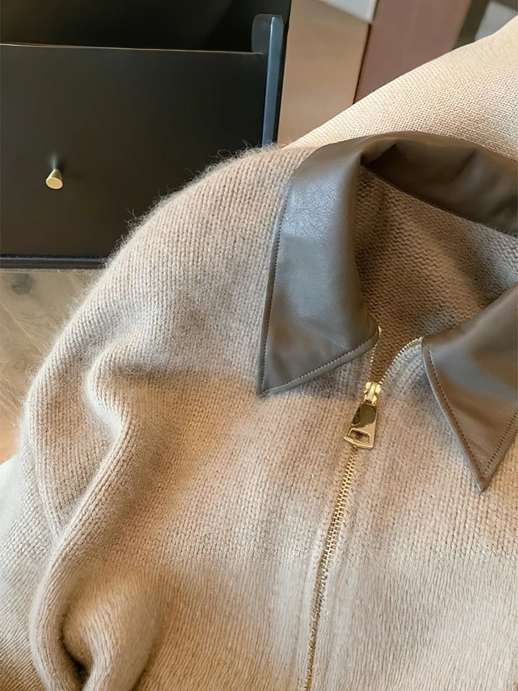 Close-up of a beige sweater with a zipper, blurred background