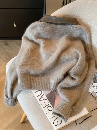 Beige sweater draped over a chair with a magazine underneath