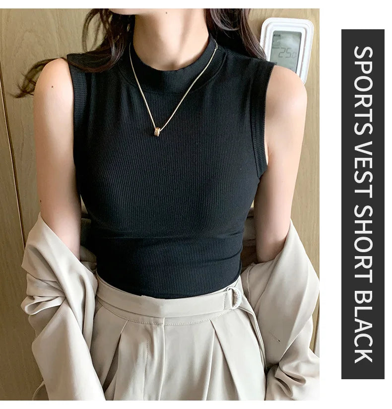 Person wearing a black sports vest and beige pants with a gold necklace.