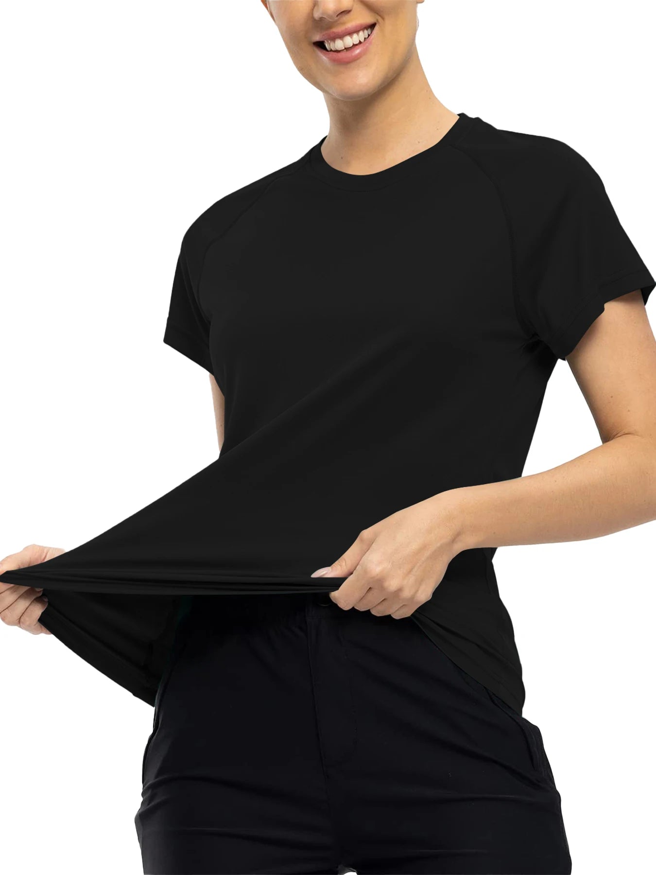 Person wearing a black t-shirt and shorts, stretching the fabric.