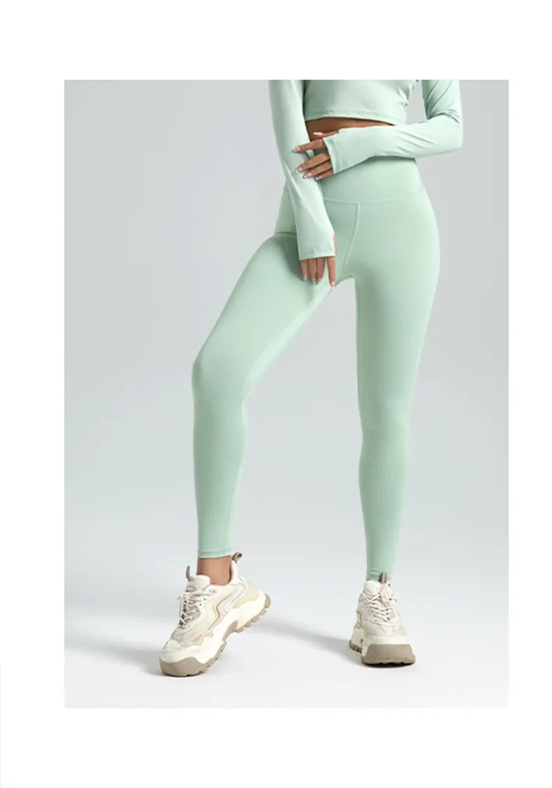 Person wearing a light green athletic outfit on a white background