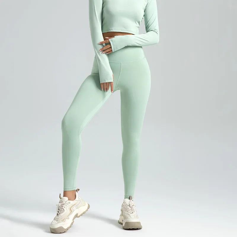 Person wearing a mint green athletic outfit on a light gray background
