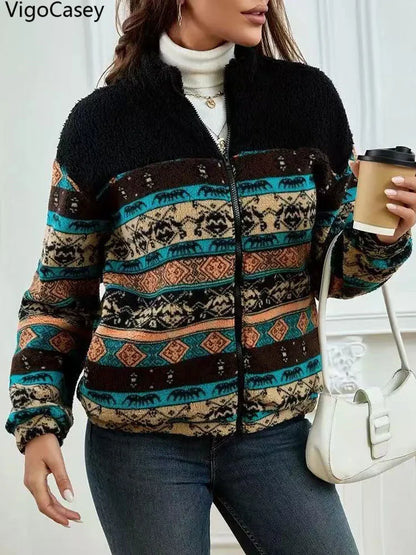 Person wearing a patterned jacket holding a coffee cup indoors
