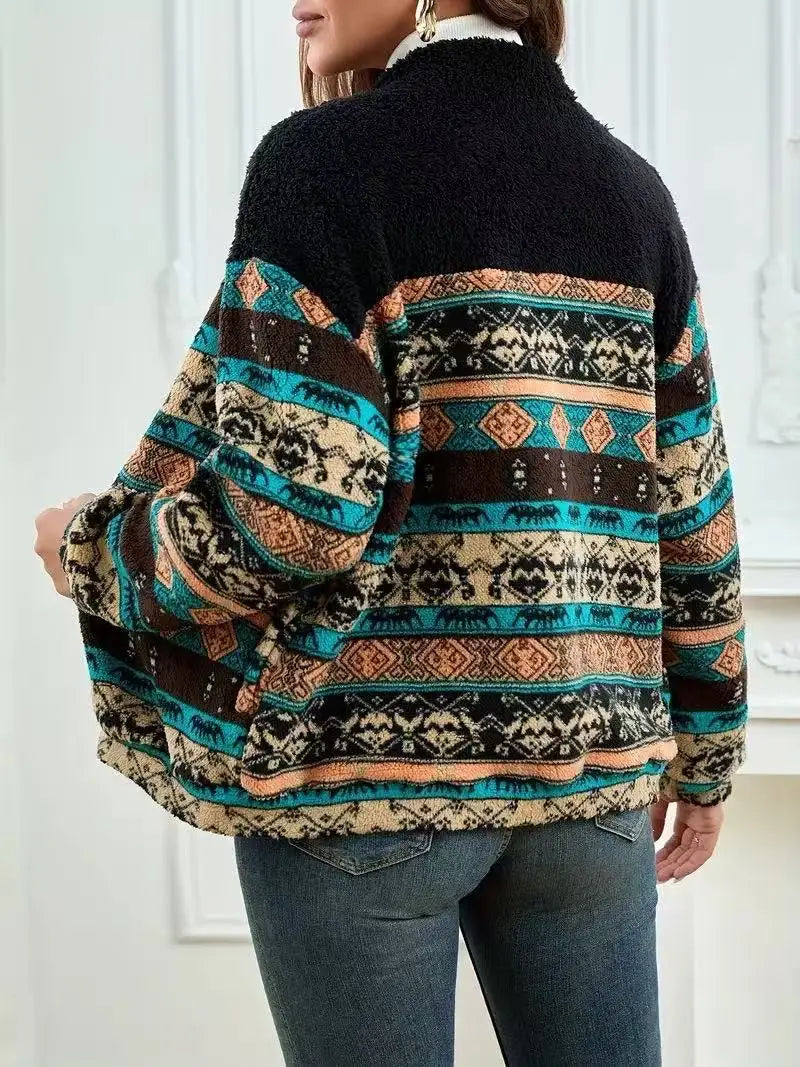 Person wearing a patterned sweater with a black collar against a white background