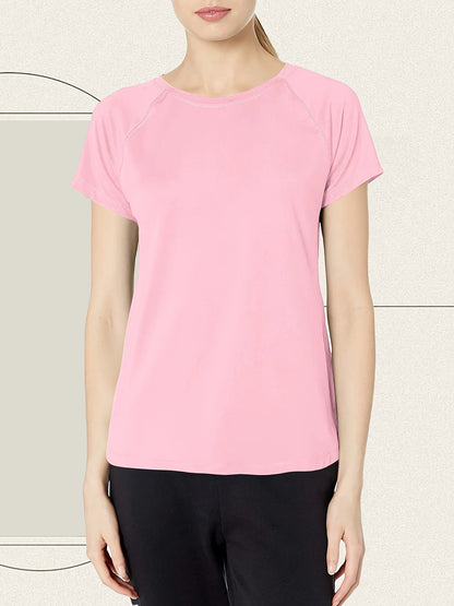 Person wearing a pink t-shirt and black pants on a light background