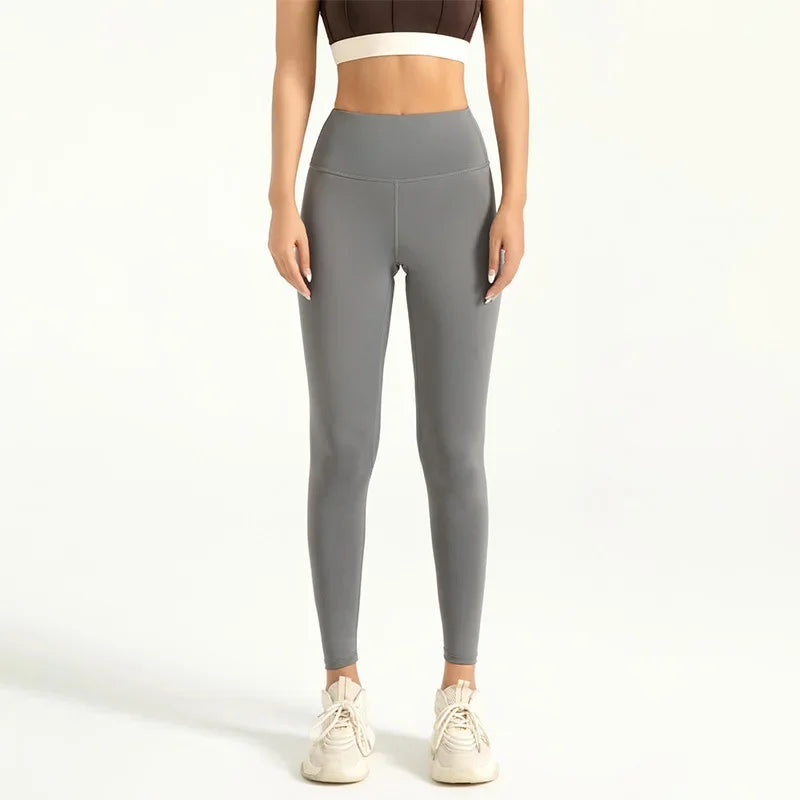 Person wearing gray leggings on a white background