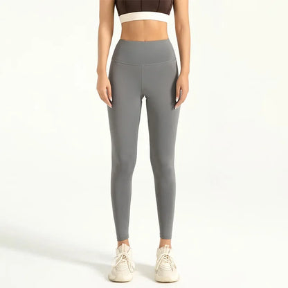 Person wearing gray leggings on a white background