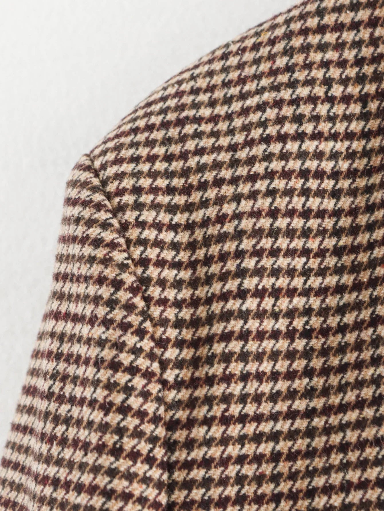 Close-up of a houndstooth patterned fabric on a white background