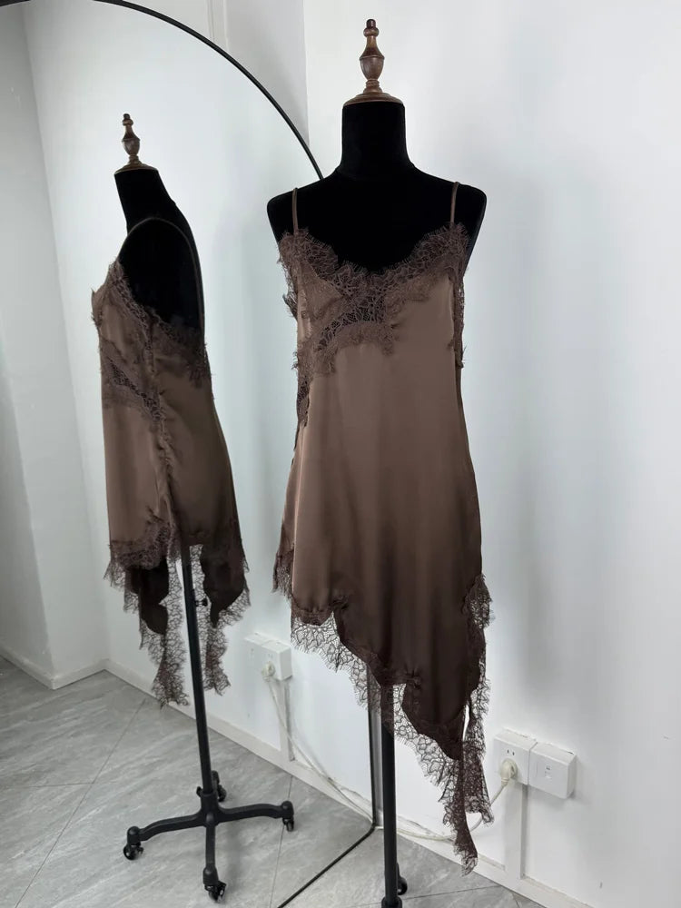 Brown lace dress on a mannequin against a white wall