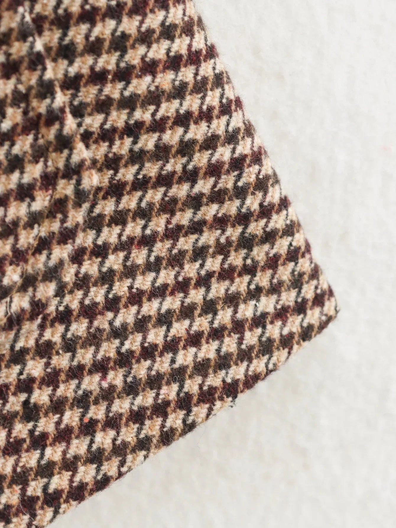 Close-up of houndstooth pattern fabric on a light background