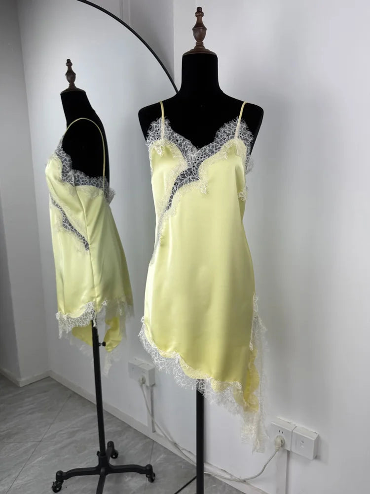 Yellow lace-trimmed nightgown on a mannequin against a white wall.