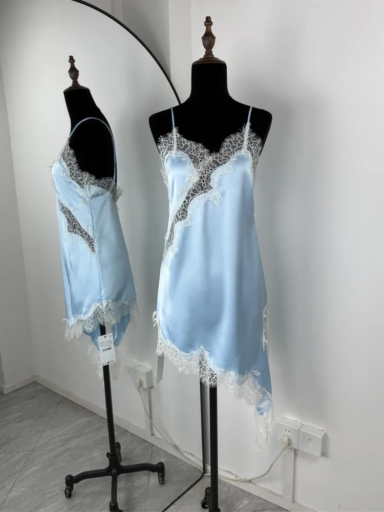 Light blue satin nightgown with lace details on mannequins against a white wall.