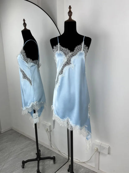 Light blue satin nightgown with lace details on mannequins against a white wall.