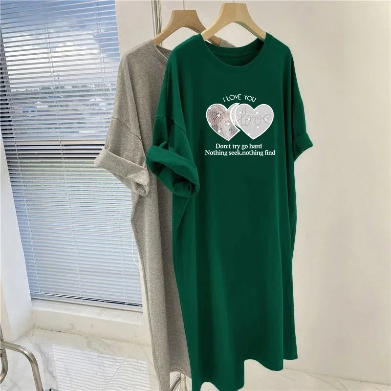 Green t-shirt with printed design on a hanger against a window background
