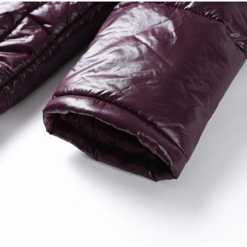 Purple quilted comforter on a white surface