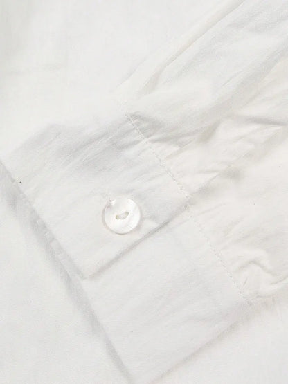 Close-up of a white quilted fabric with a button