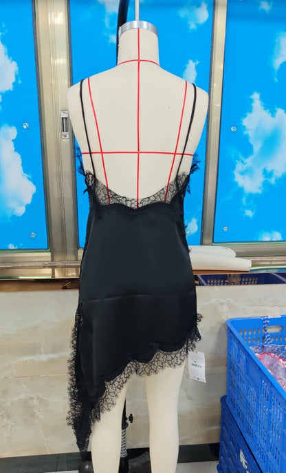 Black lace dress on a mannequin against a blue sky with clouds background