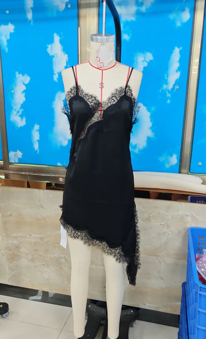 Black lace nightgown on a mannequin against a blue screen with white cloud patterns.
