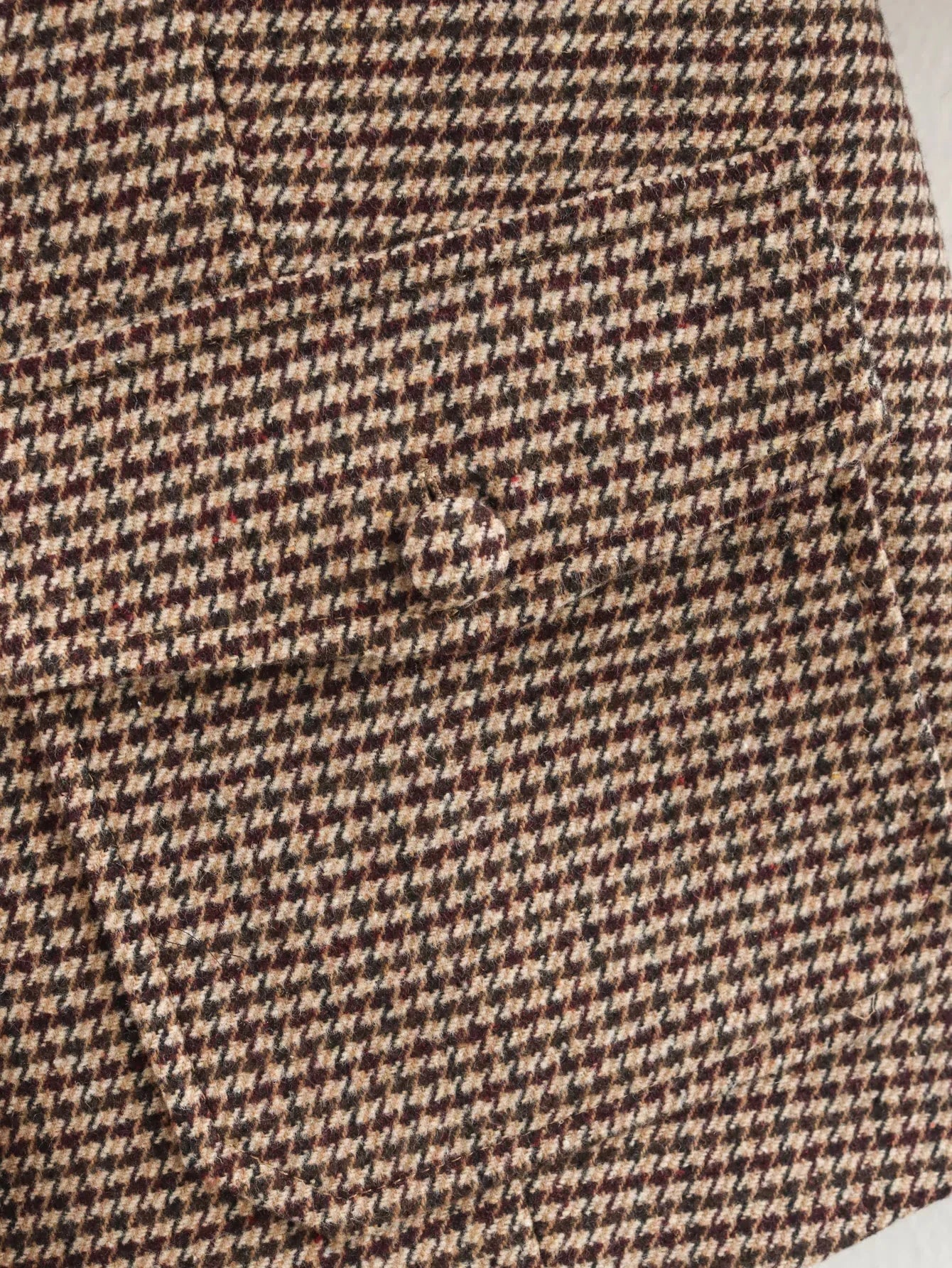 Close-up of a brown and beige houndstooth pattern fabric