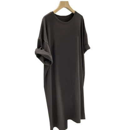 Dark gray dress on a wooden hanger against a white background