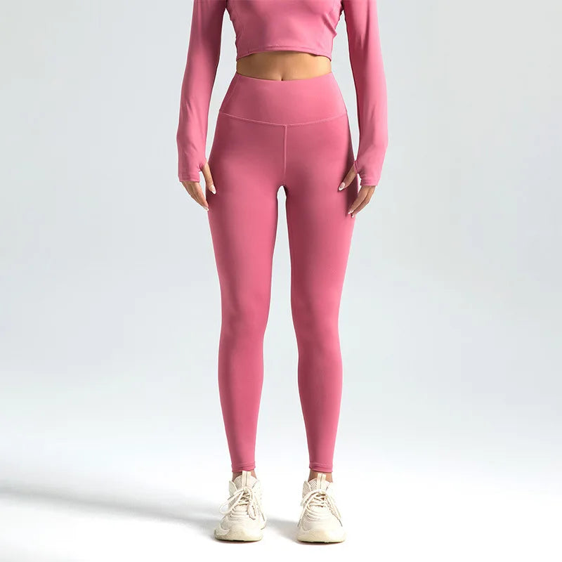 Person wearing pink athletic outfit on a light gray background