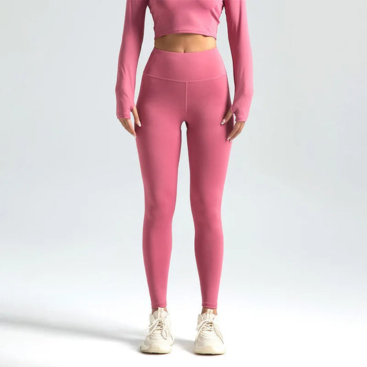 Person wearing pink athletic outfit on a light gray background