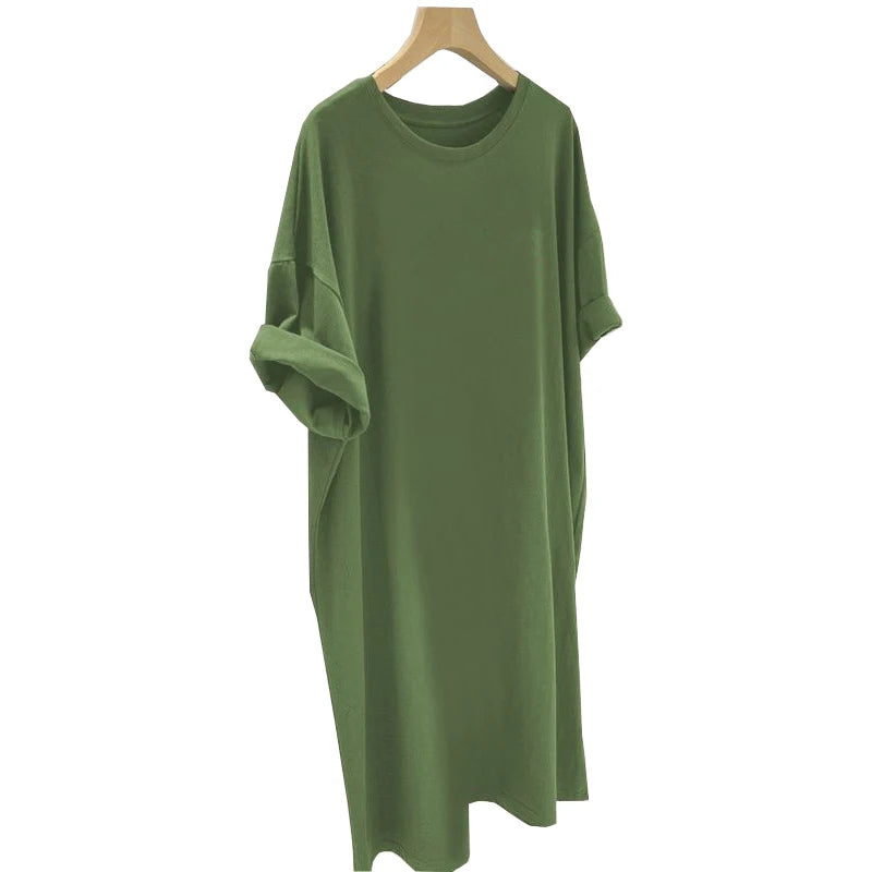 Green dress on a wooden hanger against a white background