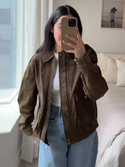 Person wearing a brown jacket in a bedroom setting