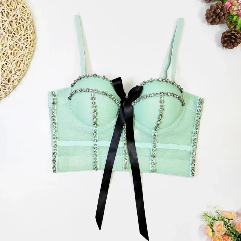 Light green bra with decorative black ribbon on a white background