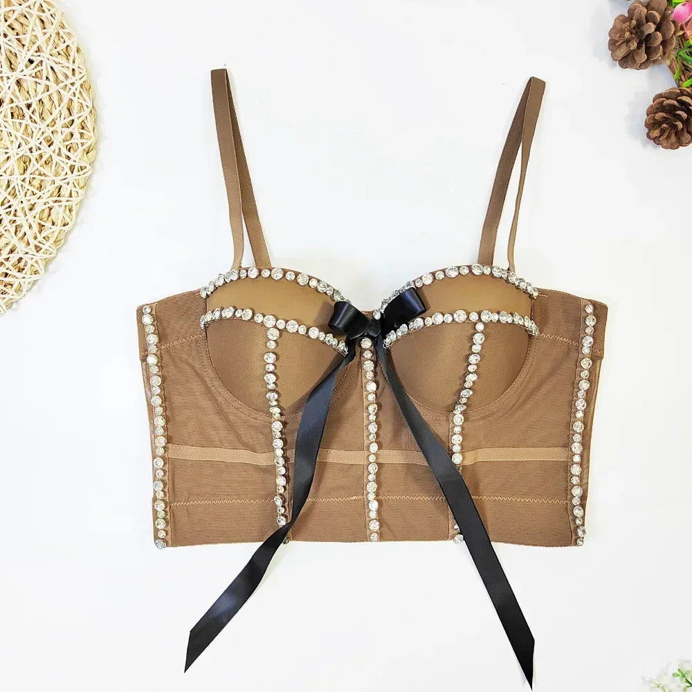 Brown bra with pearl details and a black ribbon on a white background