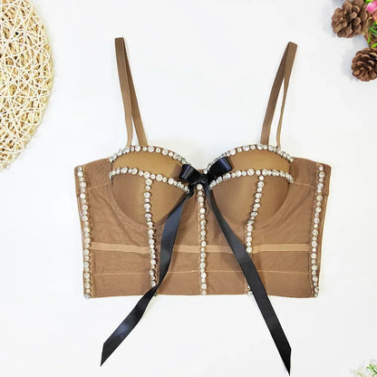 Brown bra with pearl details and a black ribbon on a white background