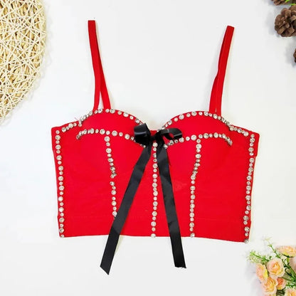 Red bra with black bow and pearl embellishments on a white background