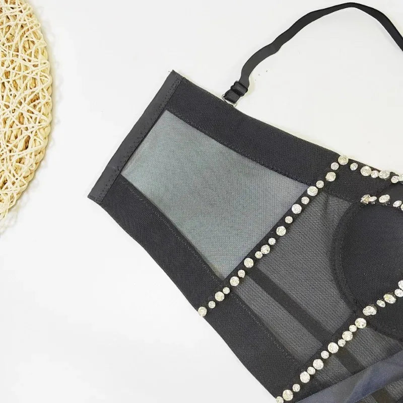 Black mesh pouch with pearl embellishments on a white background