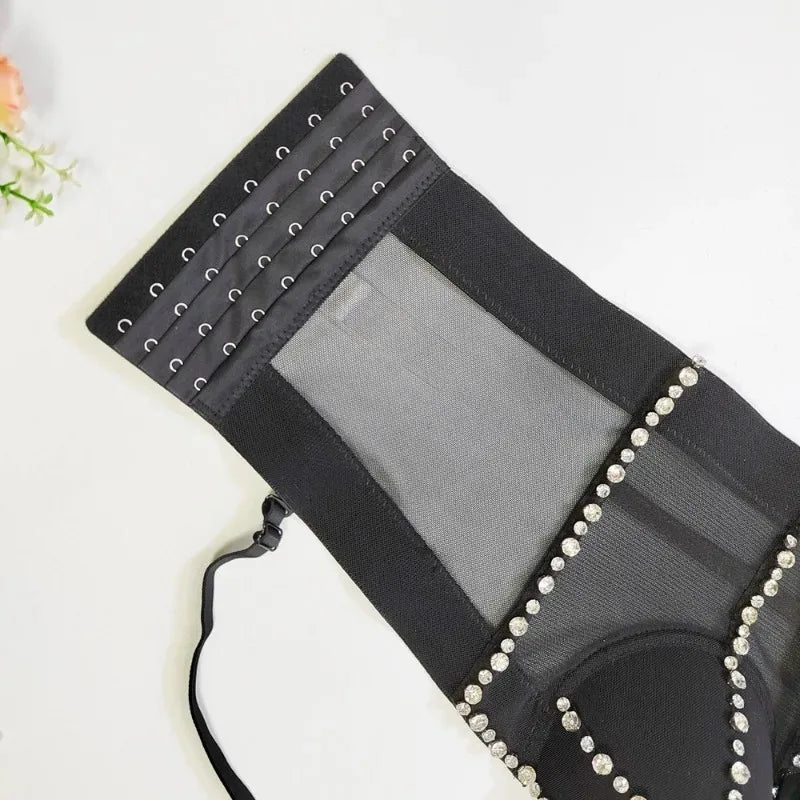 Black clutch bag with rhinestone embellishments on a white background