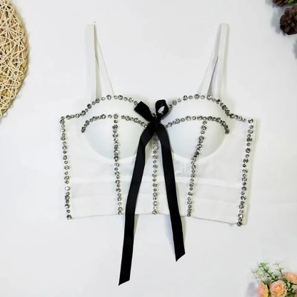 White lace top with black ribbon on a white background