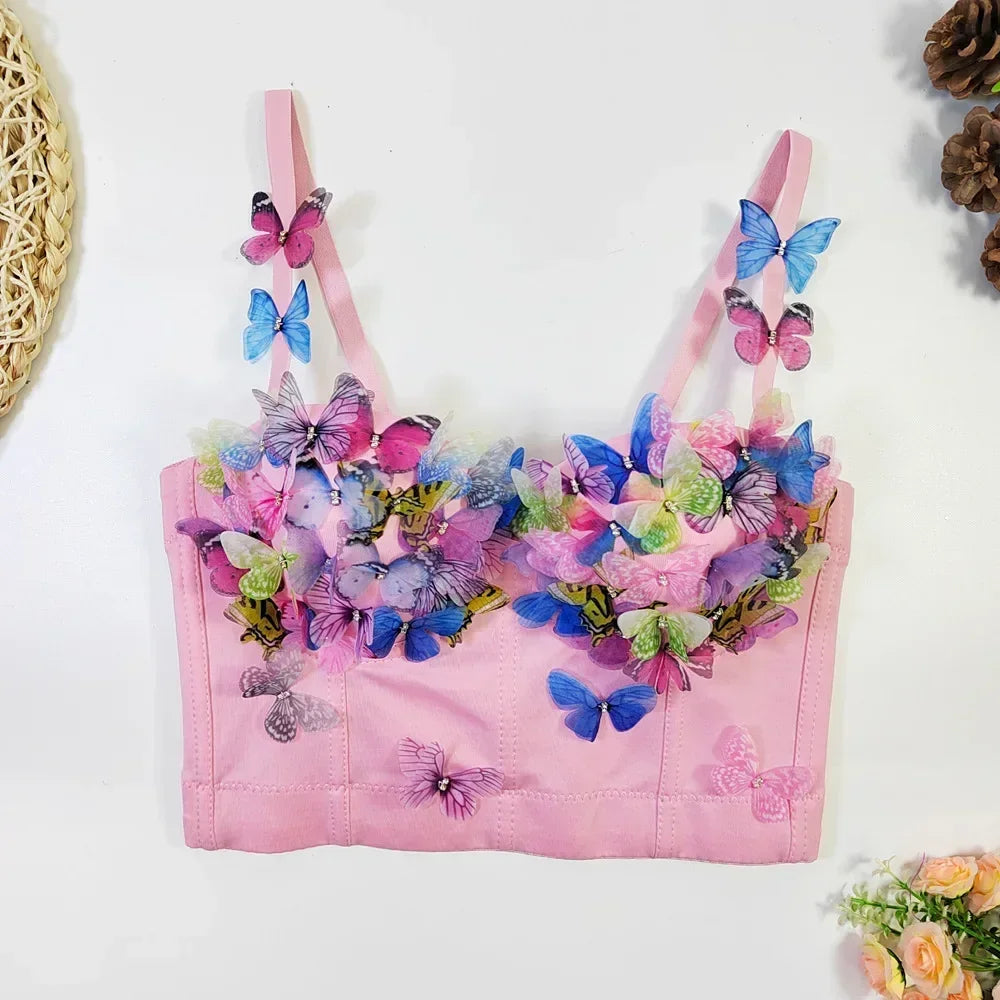 Pink bra with colorful butterfly designs on a white background