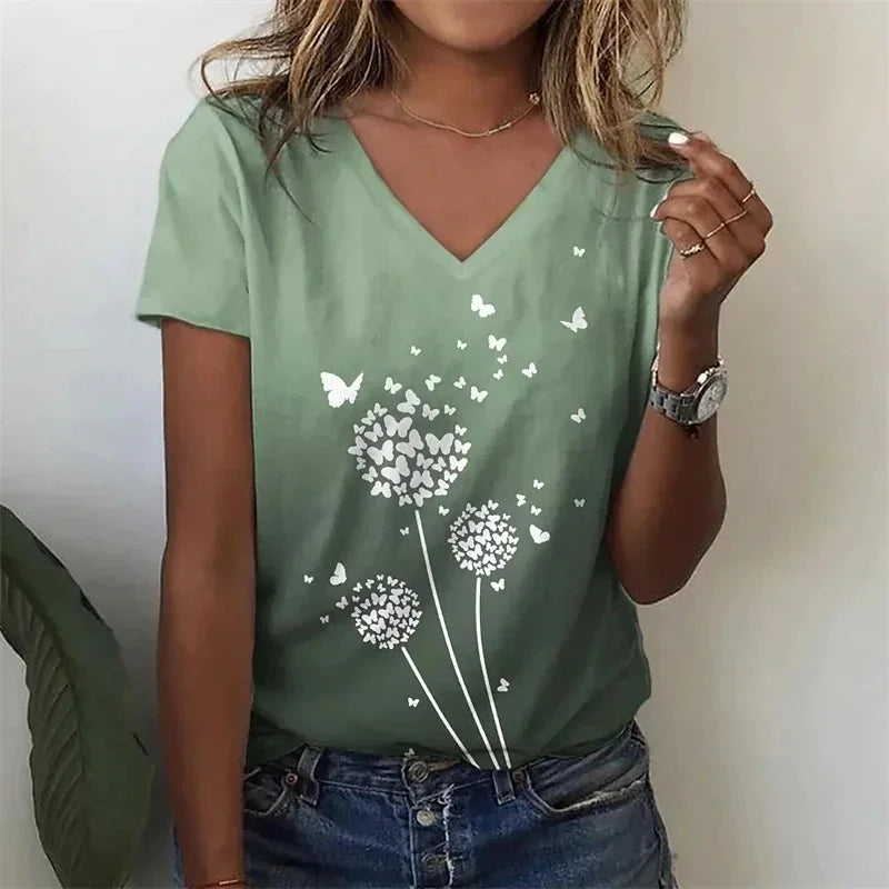 Person wearing a green t-shirt with dandelion and butterfly design.