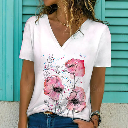 Person wearing a white t-shirt with pink floral design against a turquoise background